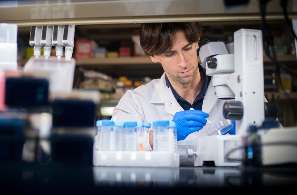 Leukaemia UK funded researcher, Miguel Ganuza Fernandez PhD, using a pipette with sample tubes in a laboratory