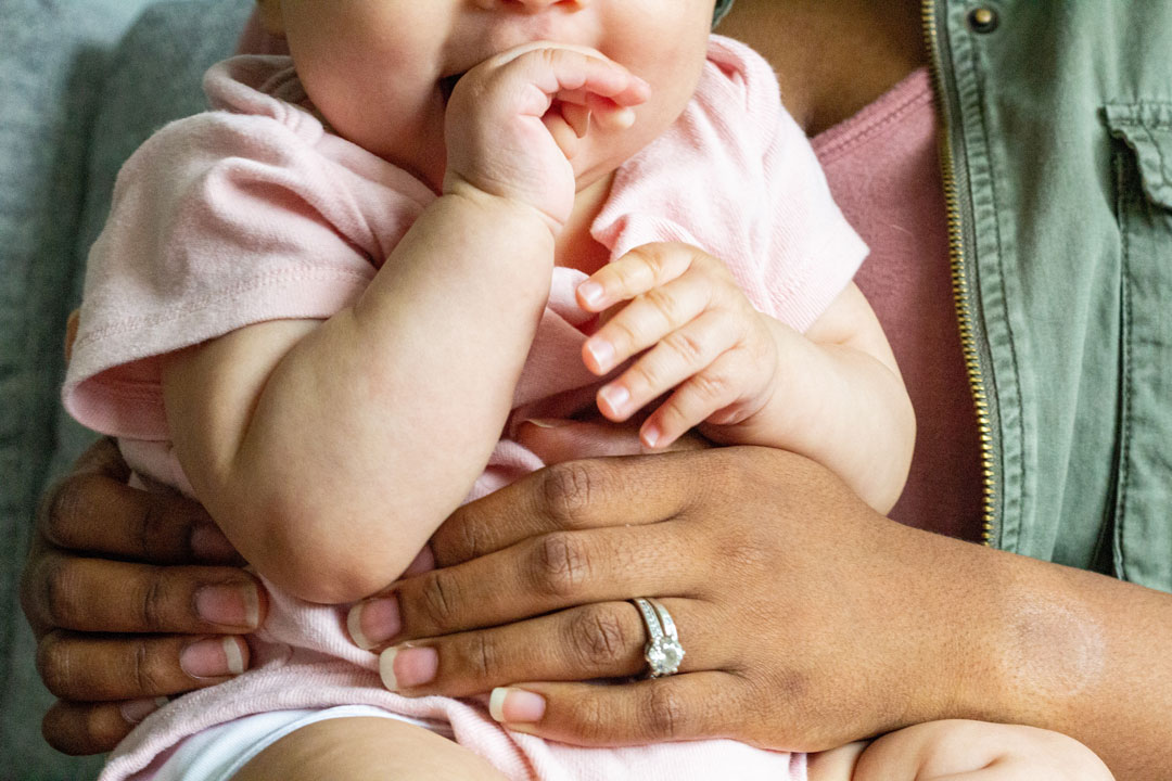 Baby being held in womans lap