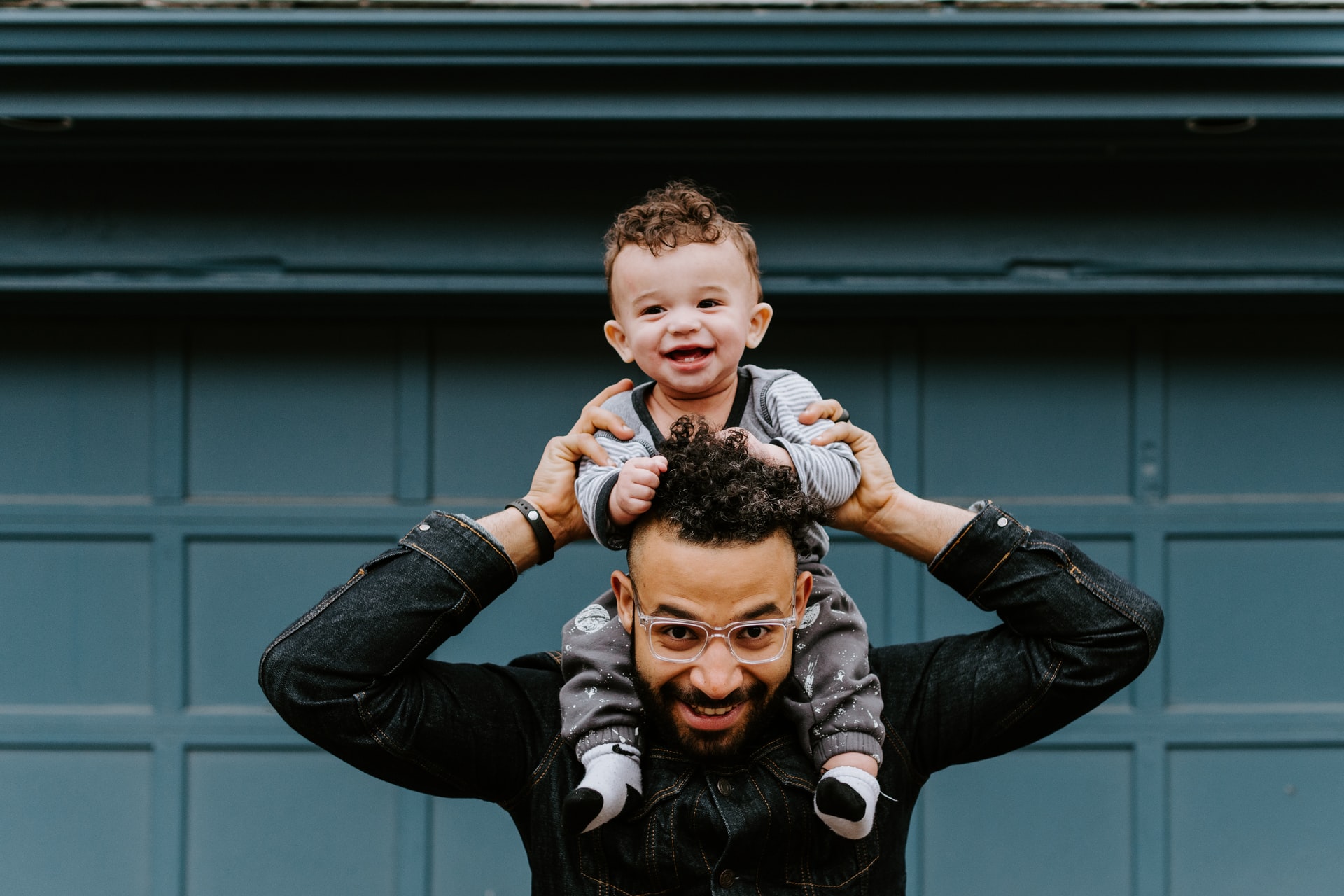 Happy man with toddler on his shoulders