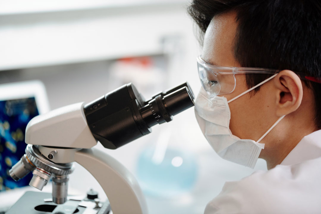 Man looking into microscope