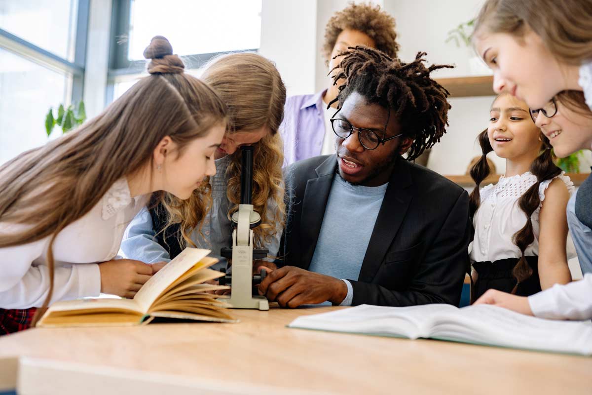 group of children looking at microscope