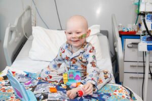 Vinnie sat in bed in hospital during treatment