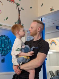 Vinnie's Dad holding Vinnie in the hospital
