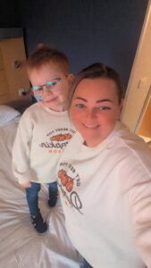 Vinnie's mum taking a selfie whilst Vinnie stands on a bed