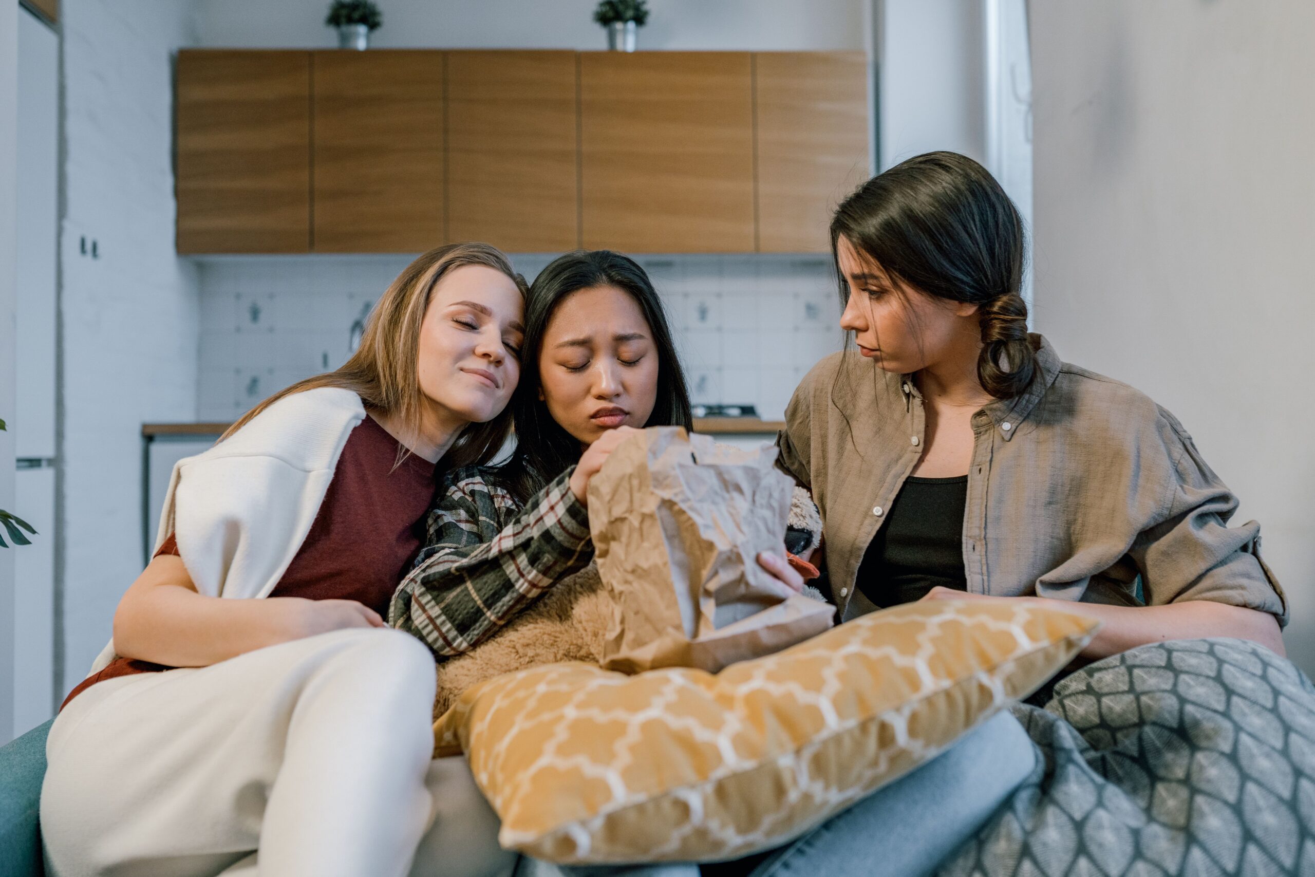 three women sitting on the sofa